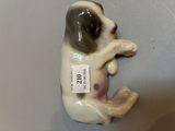 a figurine of a dog with a tag on it