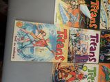 a lot of comic books on the table together
