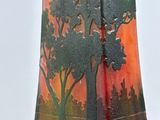 a vase that has a painting of a tree on it