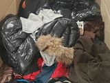 a cardboard box filled with clothes and other items
