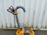 a yellow machine that is sitting on the ground
