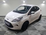 a picture of a small white car parked in a garage