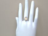 a white mannequin hand with a ring on it
