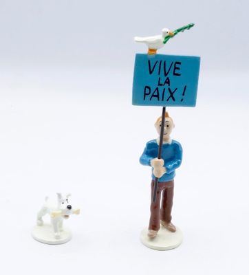 figurine of a man holding a sign with a dog nearby