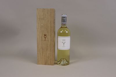 a bottle of white wine next to a wooden box