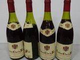 four bottles of wine are lined up on a table