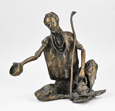 statue en bronze représentant un homme agenouillé sur un rocher, coiffé d'un chapeau et muni d'une canne
