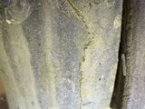a close up of a stone vase with a bird on it