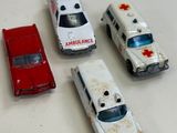 four toy ambulances sitting on a table next to each other