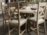 a wooden table with four chairs and a bowl on it