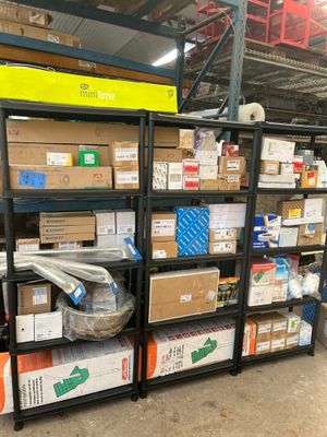 many boxes and packages on the shelves in the warehouse
