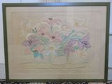 painting of a bouquet of flowers in a green frame on a rug
