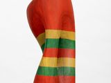 an image of a sculpture of a woman ' s head with a red, green and yellow stripe on it