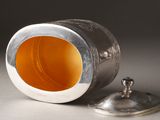 a silver container with a lid and a lid on a table