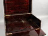 a small wooden box that is open on a white surface