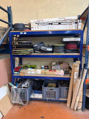 a blue shelf with many items on it in a room