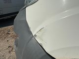 a white van that is parked on the side of the road