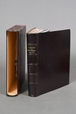 an open book sitting on top of a table next to a closed book