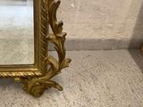 a mirror that is sitting on the floor next to a wall