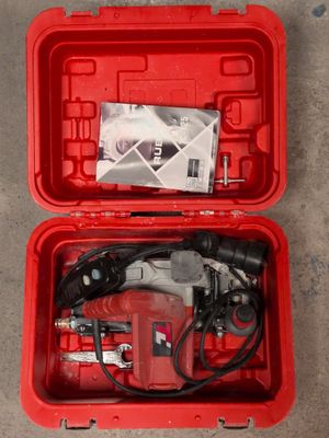 the tools are in the red case on the concrete floor