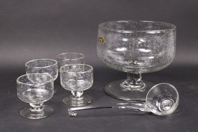 four glasses and a spoon sitting on a table