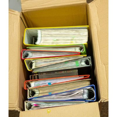 a box full of files sitting on the floor
