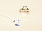a close up of a ring with a blue stone on it