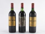 three bottles of wine sitting next to each other on a white surface
