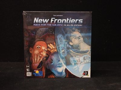 a box of new frontiers on a black surface