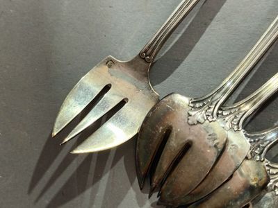 a silver spoon and a fork on a table