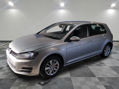 the silver volkswagen golf is parked in a large room