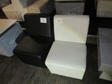 a white chair and a black chair next to each other