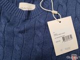 the sweater is blue and has a price tag on it