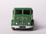 a green toy truck that is sitting on a white surface