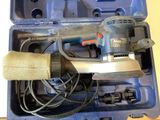 a sander in a case with a cord in it