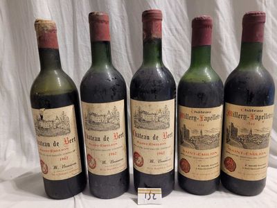 four bottles of wine are lined up on a table