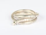 silver snake ring with emerald eyes on a white background