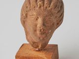 statue of a woman ' s head on a wooden base