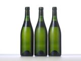 three bottles of wine are lined up in a row on a table