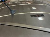a parking meter on the roof of a car in a parking lot