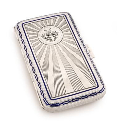 a silver cigarette case with a picture of a sunburst on it