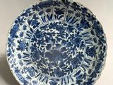 a blue and white plate with a floral design on it