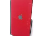 the back of a red iphone sitting on top of a stand