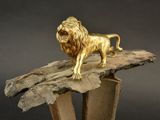 a statue of a lion standing on top of a tree stump