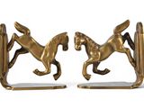 pair of antique brass horse bookends on white background