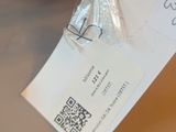 someone is holding a piece of paper with a qr code attached to it