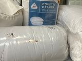 a pile of pillows on a shelf in a store