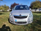 a silver car that is parked in the grass