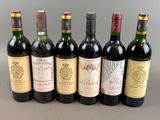 several bottles of wine are lined up on a table