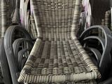 many wicker chairs stacked on top of each other